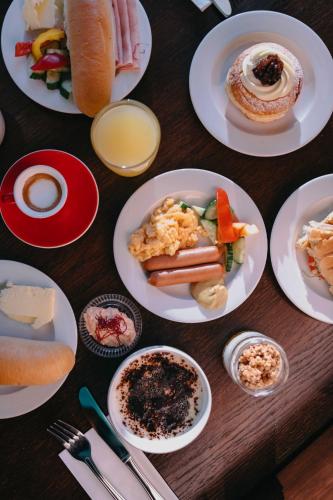 a wooden table with plates of food on it at OREA Resort Panorama Moravský kras in Blansko