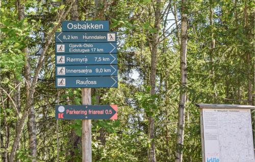 a street sign in front of some trees at Holiday Home Hunndal Skumlivegen in Raufoss