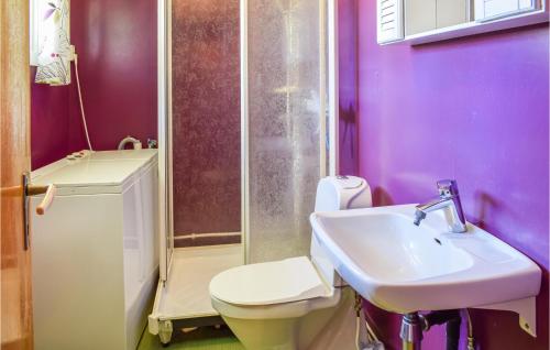 a purple bathroom with a toilet and a sink at Holiday Home Hunndal Skumlivegen in Raufoss