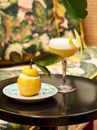 a table with a drink and an orange on it at Mama Shelter Nice in Nice