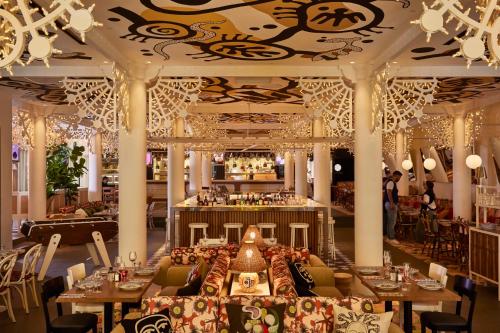 a restaurant with couches and a bar in the background at Mama Shelter Nice in Nice