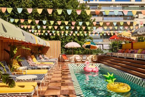 a swimming pool with a pink pig in the water at Mama Shelter Nice in Nice