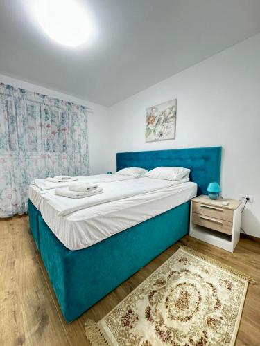 a bedroom with a blue bed and a night stand at Vila Kraljica 2 - apartman 7 in Vrdnik