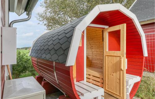 a small red house with a door on the outside at Cozy Home In Zerpenschleuse With Wifi in Zerpenschleuse