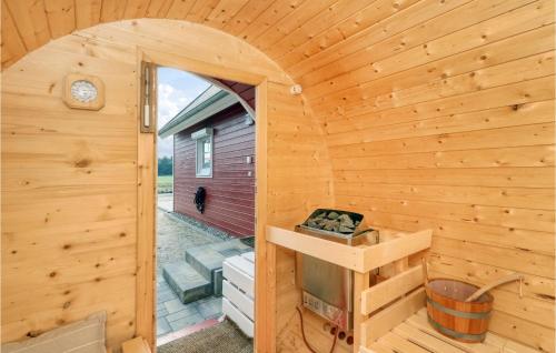 a wooden cabin with a door open to a patio at Cozy Home In Zerpenschleuse With Wifi in Zerpenschleuse