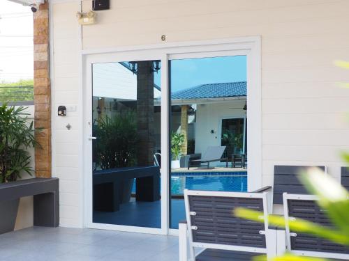 a sliding glass door leading to a swimming pool at Mangoes Pattaya in Na Jomtien