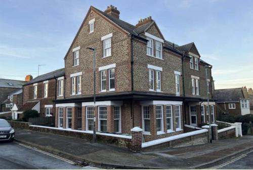 a large brick building on a city street at Victorian Villa, Hunstanton Norfolk Sleeps 20 in Hunstanton