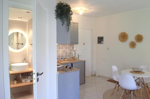 a kitchen with a sink and a table with chairs at Beyond in Argostoli