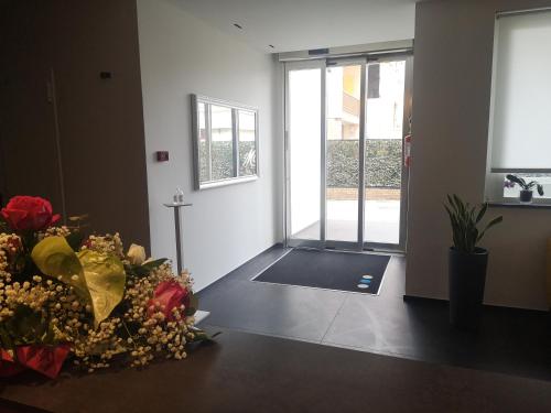 an empty room with a door with flowers on the floor at Hotel Mediterraneo in Martinsicuro