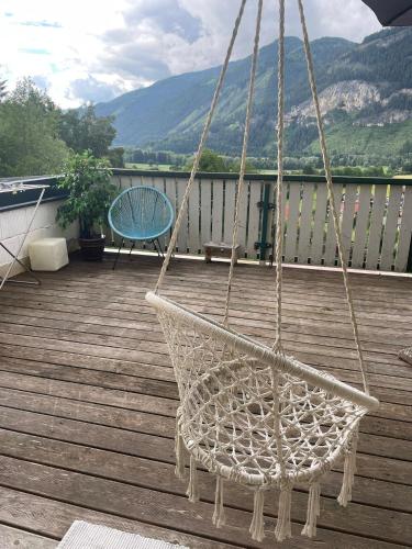 a hammock hanging on a deck with a chair at Haus Leona in Teufenbach