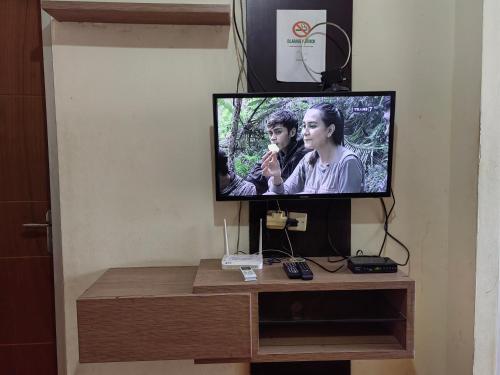 a flat screen tv sitting on top of a table at Cibubur Village By Arsakha Property Management in Cibubur