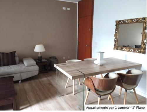 a living room with a table and chairs and a couch at Milano 3 Astra Apartments & Rooms in Basiglio