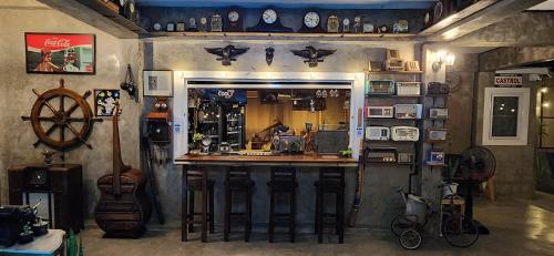 a bar in a room filled with lots of items at Seven 50s in Pai