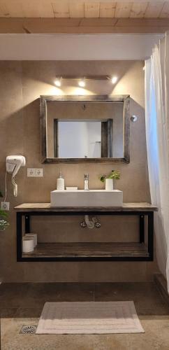 a bathroom with a sink and a mirror on the wall at Studio Zoi in Matala