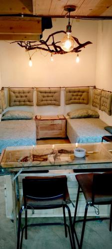 a room with two beds and a table with chairs at Agriturismo Parco dai Nonni in Ischitella