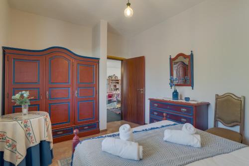 a bedroom with two beds and a dresser at Sa Dias House by AH in São Jorge
