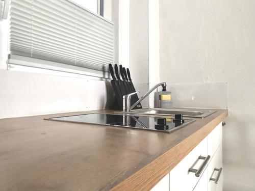 a kitchen with a sink and a counter top at City Apartment No1 in Reutlingen