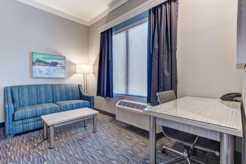 a hotel room with a couch and a table at Hotel Peppertree Bend, BW Premier Collection in Bend