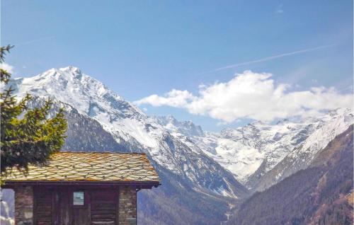 a view of a snow covered mountain with a building at Isolina in Valsavarenche