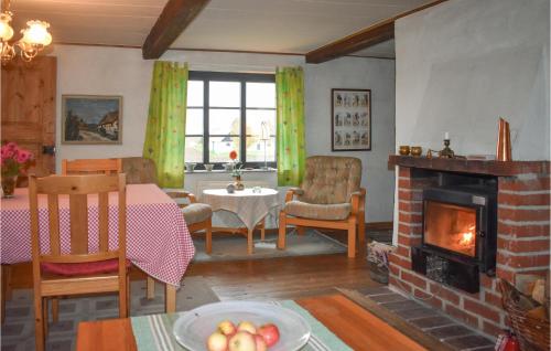 a living room with a table and a fireplace at Holiday Home Simrishamn Lxxv in Gladsax