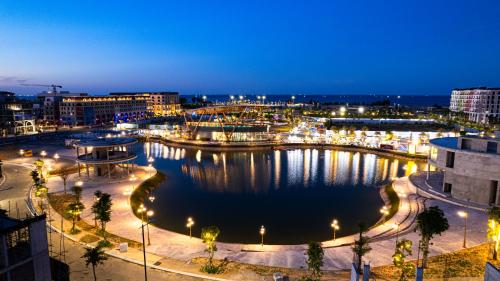 a city at night with a large body of water at Regal Collection House in Dương Cảnh