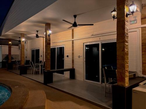 a room with a swimming pool and a house at Mangoes Pattaya in Na Jomtien