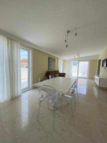 a dining room with a table and chairs in a living room at Historico Loft & Rooms Palazzo Adragna XIX in Trapani
