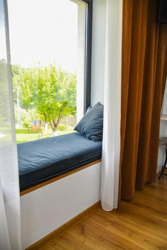 a window sill with a bed in front of a window at Vila MOON in Bezdead