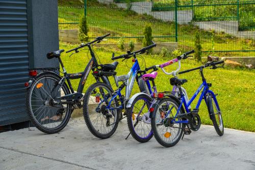 four bikes parked next to each other on a sidewalk at Vila MOON in Bezdead