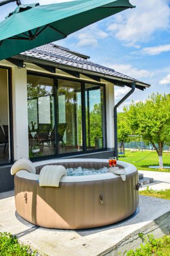 a large hot tub in front of a house at Vila MOON in Bezdead