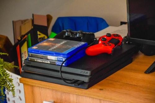 a video game controller sitting on top of a dvd player at Vila MOON in Bezdead