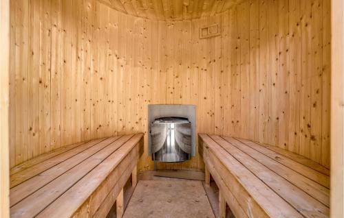 a wooden sauna with a tv in the middle at Le Coucou in Marielyst
