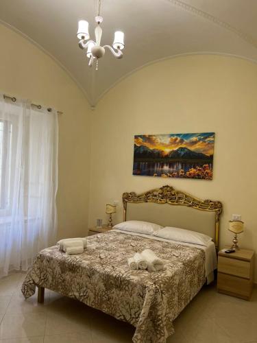 a bedroom with a bed with two towels on it at Re Umberto 311 in Naples