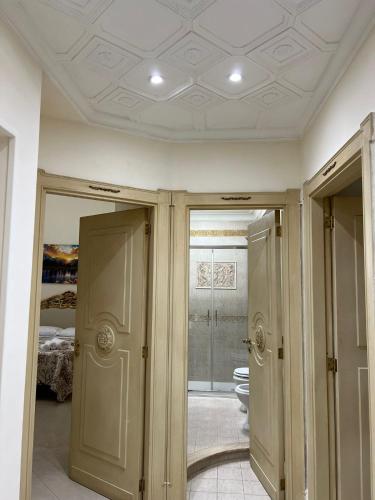 a hallway with two doors and a room with a bed at Re Umberto 311 in Naples