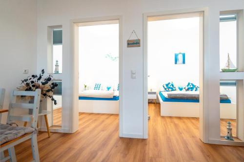a room with two beds and two mirrors at App 8u Heimatliebe in Dranske
