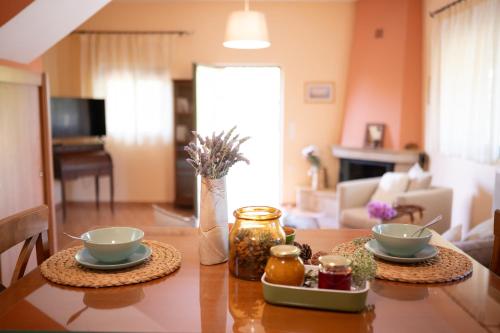 a dining room table with two bowls on it at Agrotospita Country Houses in Nafplio