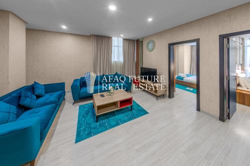a living room with a blue couch and a table at Vita Tower in Manama