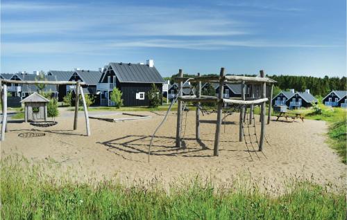 an empty playground with two swings in the sand at Nice Home In Gjern With Wifi in Gjern