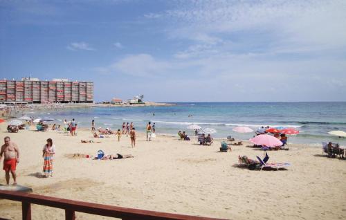 a group of people on a beach with the ocean at 2 Bedroom Cozy Apartment In Torrevieja in Torrevieja