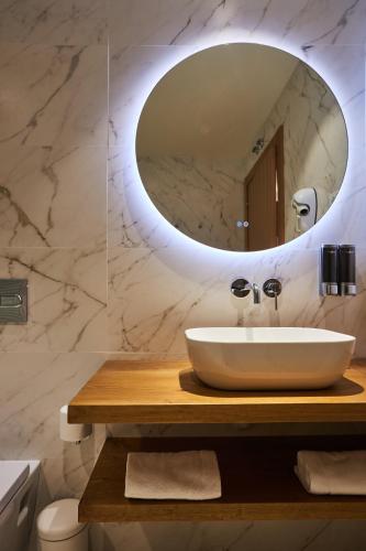 a bathroom with a sink and a mirror at La Mira de Gredos in Hoyos del Espino