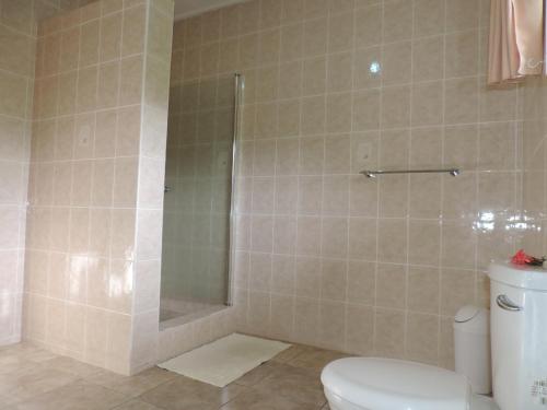 a bathroom with a shower and a toilet at Paodise Guesthouse in La Digue