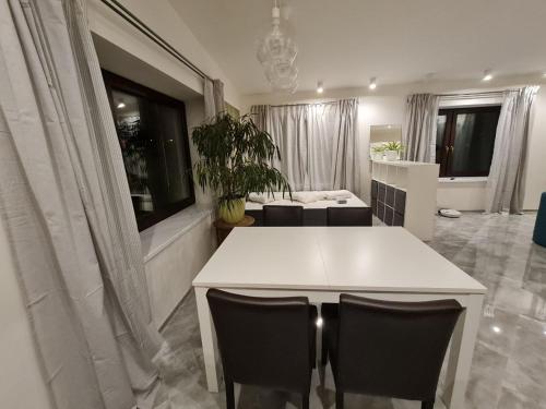a living room with a white table and chairs at Airport Private Apartment, Advance Registration, No Reception, Self Check-in, Calm Environment, Non-Smoking Guests in Kněžívka