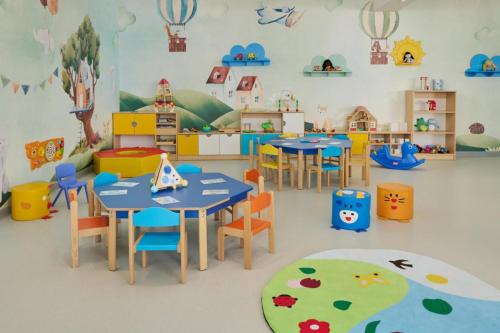 a classroom with tables and chairs in a room at Amadria Park Camping Sibenik Mobile Homes in Šibenik