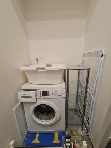 a washing machine with a sink on top of it at Airport Private Apartment, Advance Registration, No Reception, Self Check-in, Calm Environment, Non-Smoking Guests in Kněžívka