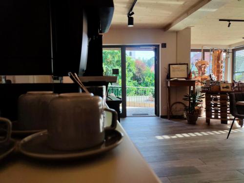 a coffee cup sitting on a counter in a kitchen at das herzstück - Schaubrennerei, Hausbrauerei & Apartments in Burghaslach