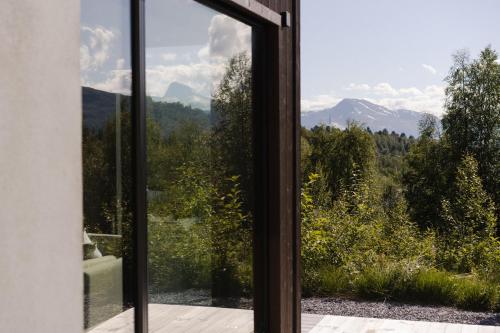 an open window with a view of the mountains at Exclusive Suite in the Sunnmøre Alps, Near Geiranger & Hjørundfjord in Stranda