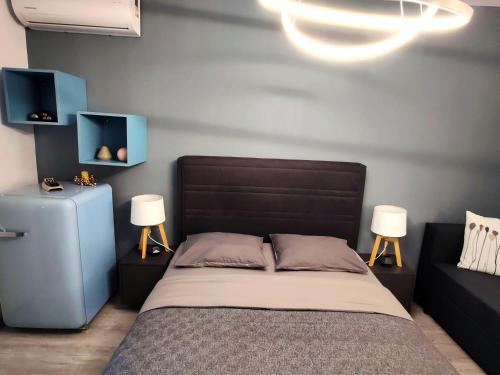 a bedroom with a bed with two night stands and two lamps at ALFA BETA RESIDENCE in Saturn