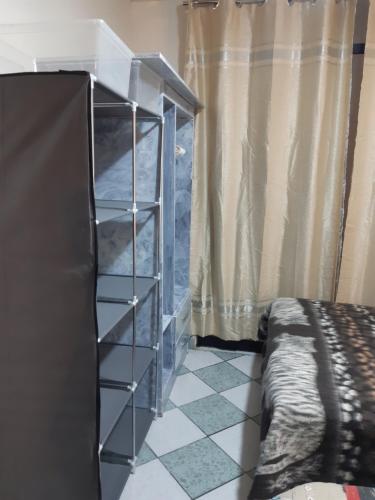 a bedroom with a book shelf next to a bed at Just for me in Lima