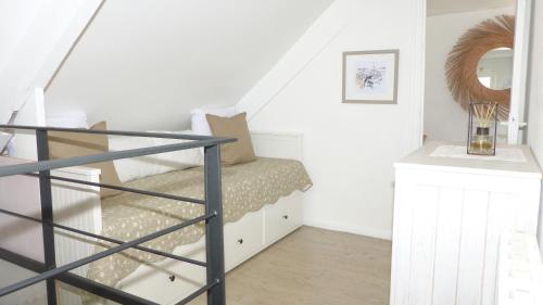a bedroom with a bunk bed and a staircase at Jolie maison de Pêcheur - Sweet Fisherman Cottage in Saint-Philibert