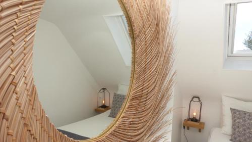 a large mirror on a wall in a room at Jolie maison de Pêcheur - Sweet Fisherman Cottage in Saint-Philibert